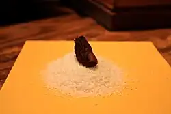 A blackened mummified toe on a pile of salt