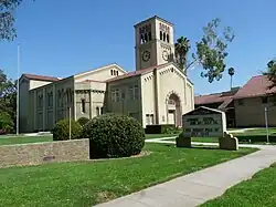 A school building with clock tower. An announcement board "South Pasadena Middle School" is visible.