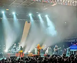 Landscape photo depicting the rock band Spoon in concert