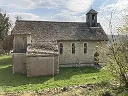 A small Cotswold stone church with small bell turret