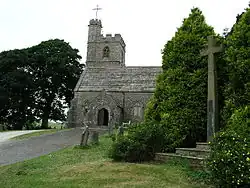 Part of a church with a tower and a higher stair turret, both battlemented