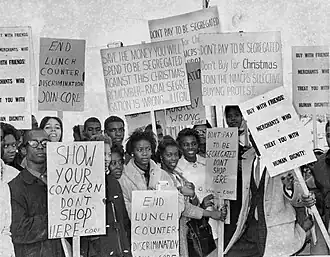 African Americans boycott discrimination and racism with signs in front of a local St. Petersburg business.