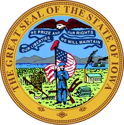 The Seal of Iowa showing a red liberty cap at the top of the soldier's flagstaff. The 1847 written description did not specify that the soldier has to wear the cap; thus he is commonly depicted with a Civil War-era cavalry hat.