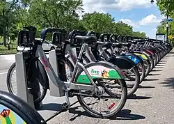 A row of parked bikes in a park