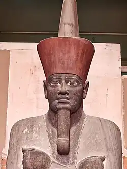 Painted osiride sandstone seated statue of pharaoh Nebhepetre Mentuhotep II, on display at the Egyptian Museum, Cairo.