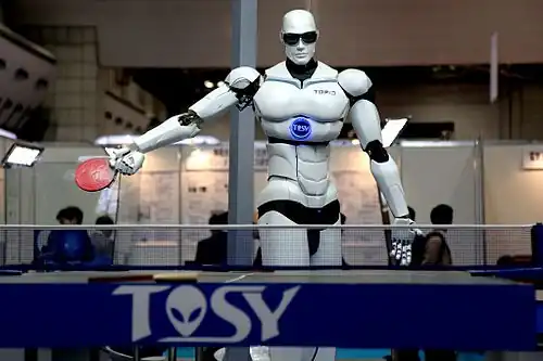 Photograph of a TOPIO humanoid ping-pong-playing robot