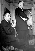 Erlander (right, standing) answering journalists' questions in 1964 with Olof Palme (left, seated)