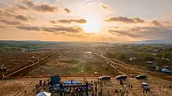 An aerial view of the Airport of the Pacific's terraformed runway and construction vehicles