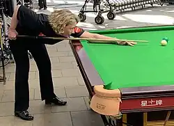 a woman playing snooker