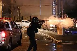 Riot Police fire tear gas to anti-government protesters during Din Daeng Protests in August 2021