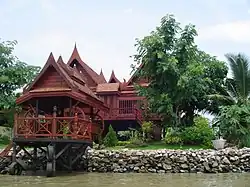 Traditional Thai-style stilt house on a canal near the Chao Phraya River in Bangkok.
