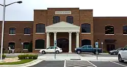 The front view of Thales Academy, featuring the entrance and the columned façade.