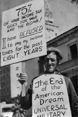 Hennacy holding up protest signs.