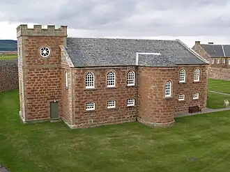 The 18th-century chapel's interior has a two-tiered arcade on three sides supported by Roman Doric columns