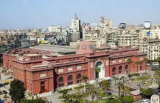 Two-story neoclassical building with arched windows and ornate facade in Cairo