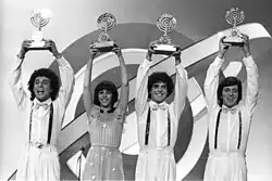 The group holding their Eurovision trophies