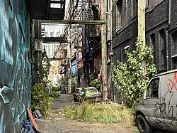 Film set of broken cars in an alley