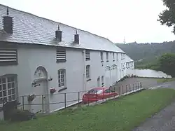 The Long Barn and attached courtyard wall, gates and railings