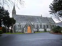 A small church with a lower chancel and an octagonal bell turret