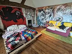 A bedroom with vibrant street art on the walls