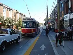 Large transport vehicle leaving sidewalk stop