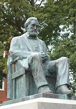 Statue of a bearded, seated man in bronze