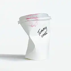 The cover artwork of "Espresso Macchiato". The cover featured a crushed coffee cup with Tommy Cash's name written in black ink. Red stains are also featured on the top of the cup.