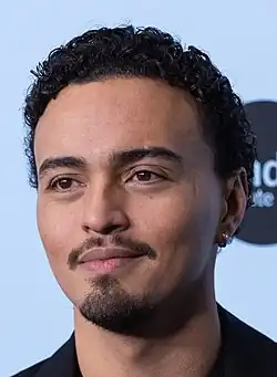 A head shot of Tonatiuh as he looks away from the camera