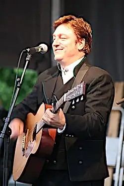 Tor Endresen performing with guitar and mic stand in 2007.