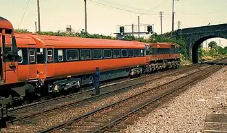 A test train is calling at the up platform as a light engine (left) waits on the up main line.28 May 1984