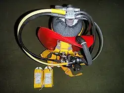 Lightweight travel diving harness - assembled with 15l steel cylinder and regulator set. A travel weight set with weights assembled stands at the cylinder base.