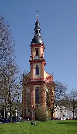 Almost straight-on view of the muted yellow, narrow, tall tower entrance of Saint Paulinus' Church