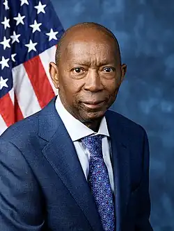 Official House portrait of Turner smiling in front of the U.S. flag, wearing a black jacket, light blue shirt, and floral blue tie.