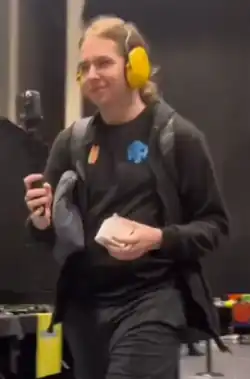 Polish speedcuber Tymon Kolasiński walking up to compete against Max Park in the UK Championship 2022