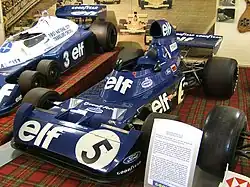 Jackie Stewart's final Grand Prix car, Tyrrell 006/2, resting on a carpet of Royal Stewart tartan in the Donington Grand Prix Collection.
