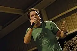 Cook speaking into a microphone