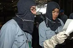 YN2 Tasha McAllister reviews muster roll during "general quarters" drill aboard USS Harry S Truman (CVN-75).