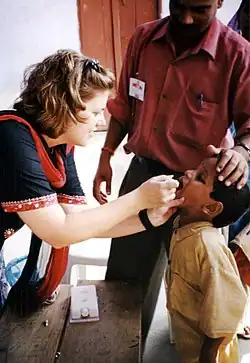 Child receiving oral polio vaccine in India