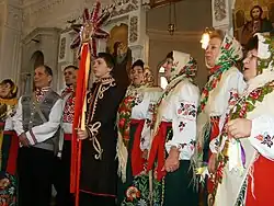 A group of people in traditional costumes in a church