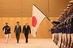 Japan Self-Defense Forces honor guards holding the national flag during Mike Pence's visit