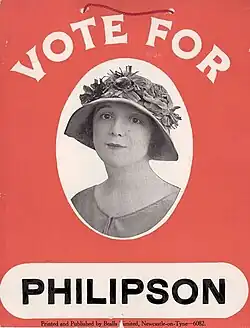 A red placard with a monochrome head-and-shoulders photo of Philipson