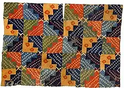 Wari tunic, Peru, 750–950 AD: This tunic is made of 120 separate small pieces of cloth, each individually tie-dyed. Ceramics of the period depict high-status men wearing this style of tunic.