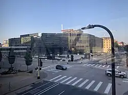 A color photograph of the facade of a blue mirror office building.