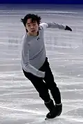 Wesley Chiu hits the ice with his right toe pick as his left blade remains on an outside edge