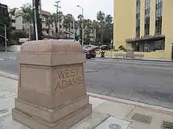 West Adams concrete marker in front of the Golden State Mutual Life Insurance Building, 2021.