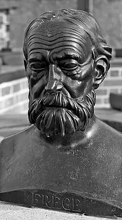 Black-and-white photo of a bronze bust of a bearded man