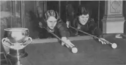 Two women at a billiard table