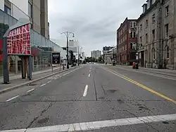 Looking west from the middle of York Boulevard from downtown Hamilton. To the left is a public library and the First Ontario Centre, and further down the street and on the right is a historic train station building.