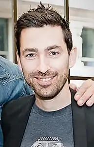 Zach Lipovsky looking at the camera and smiling