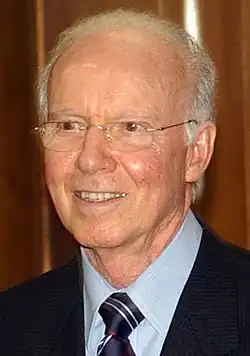 Mario Zagallo wearing glasses, a blue shirt and a tie
